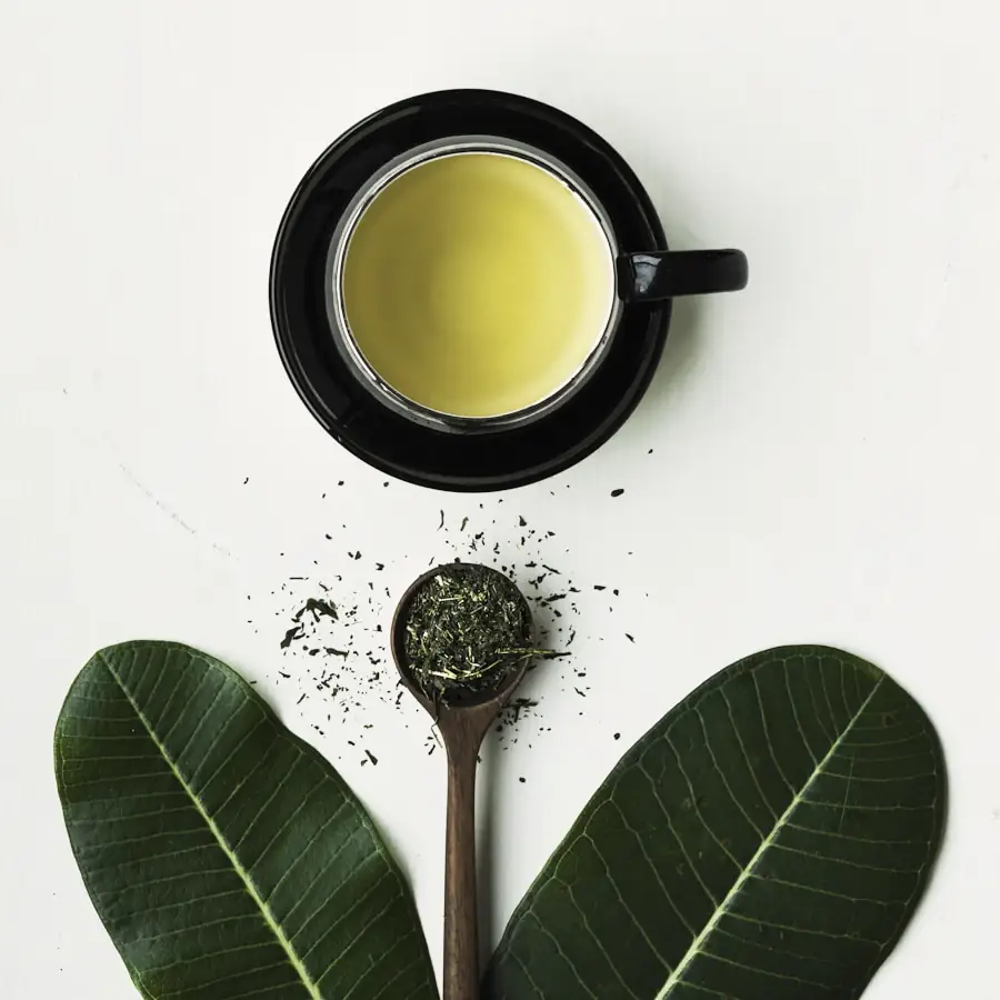 Matcha being whisked in a dark bowl